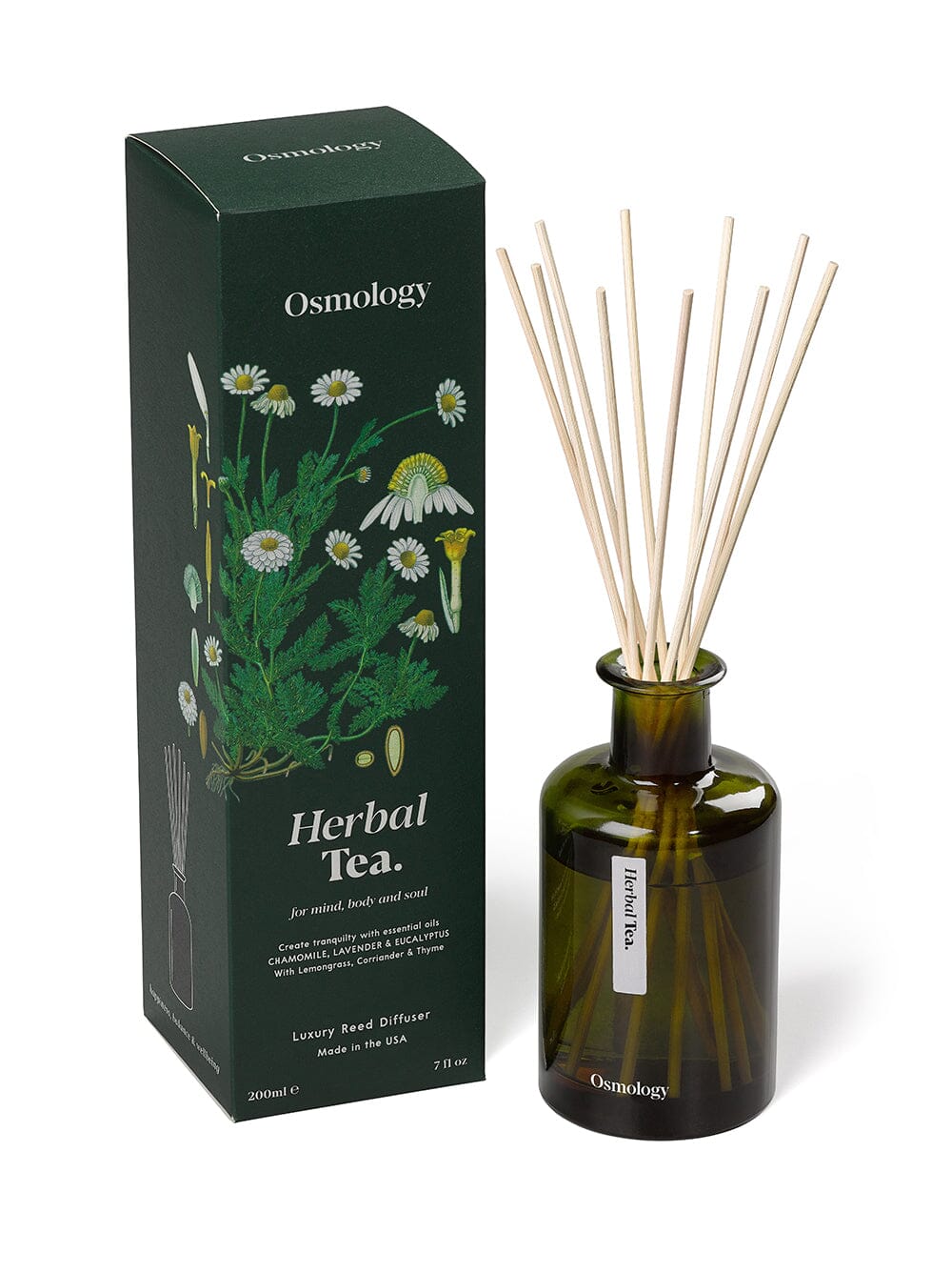 Osmology herbal tea reed diffuser in dark green glass next to product packaging on a white background