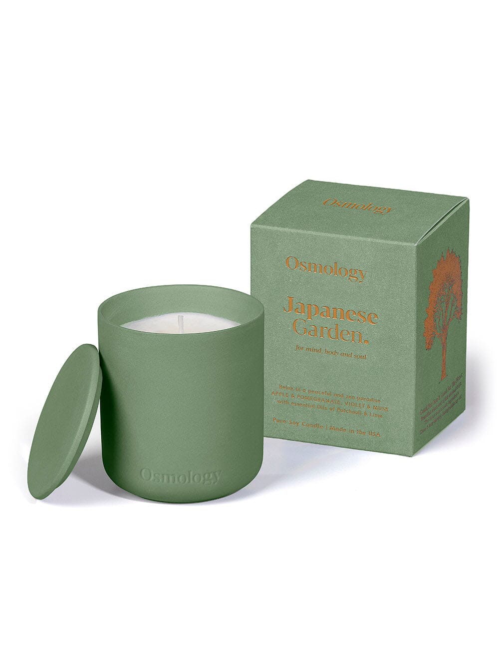 green ceramic candle with lid displayed next to product packaging