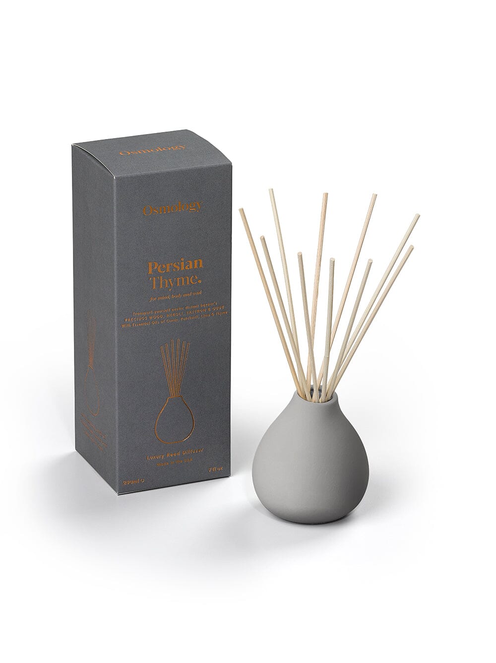 Osmology Persian Thyme grey ceramic reed diffuser next to product packaging on a white background